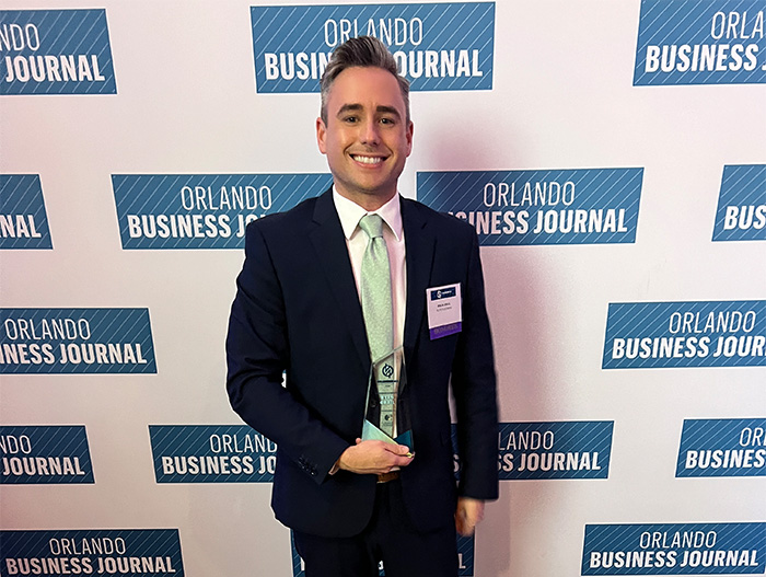 Ryan Grail in front of Orlando Business Journal backdrop